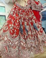 Close up of peacock embroidery on red Faux Georgette lehenga