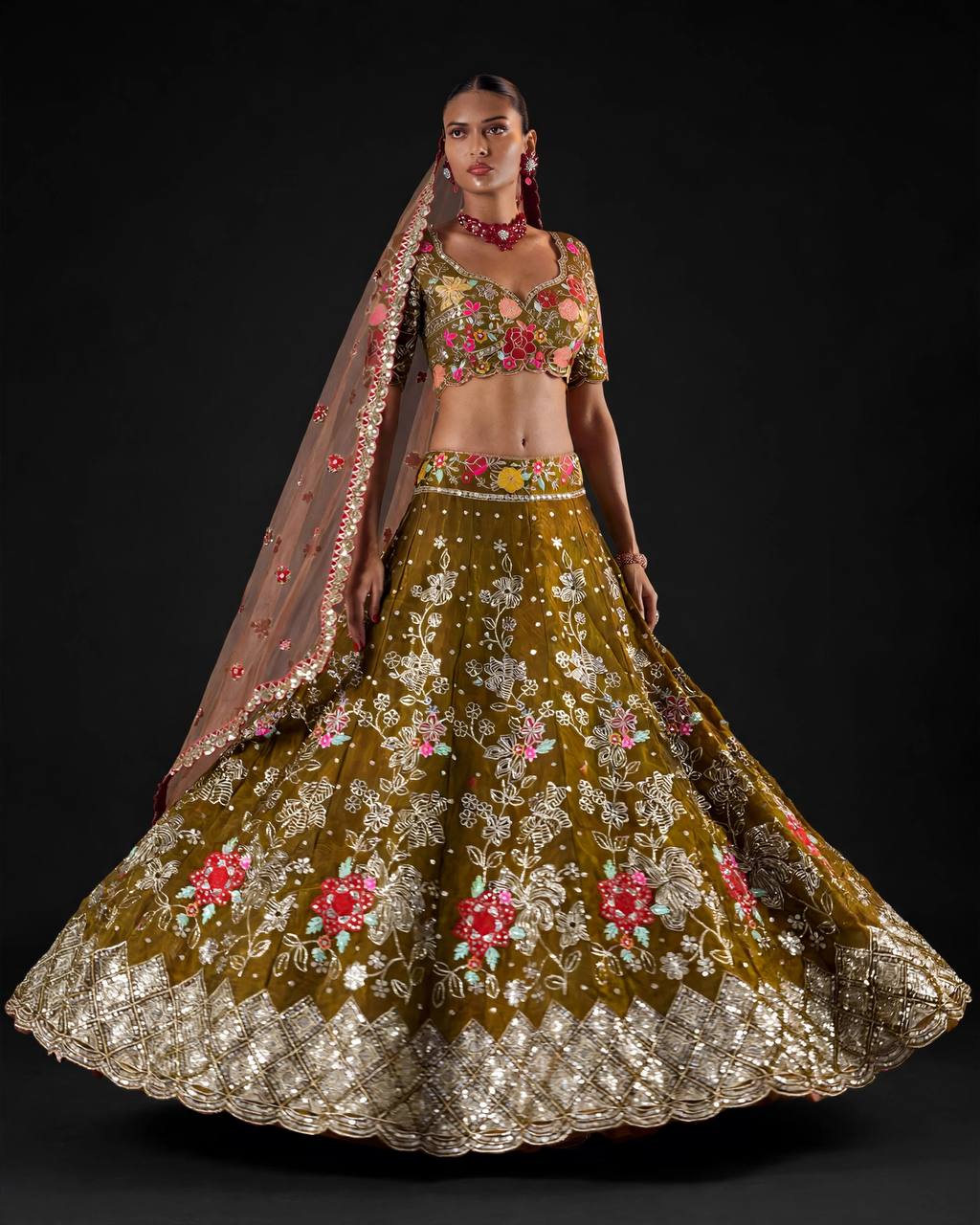 Close up of multicolor floral embroidery on olive green lehenga blouse