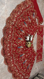 Back view of red Faux Georgette lehenga choli with blouse